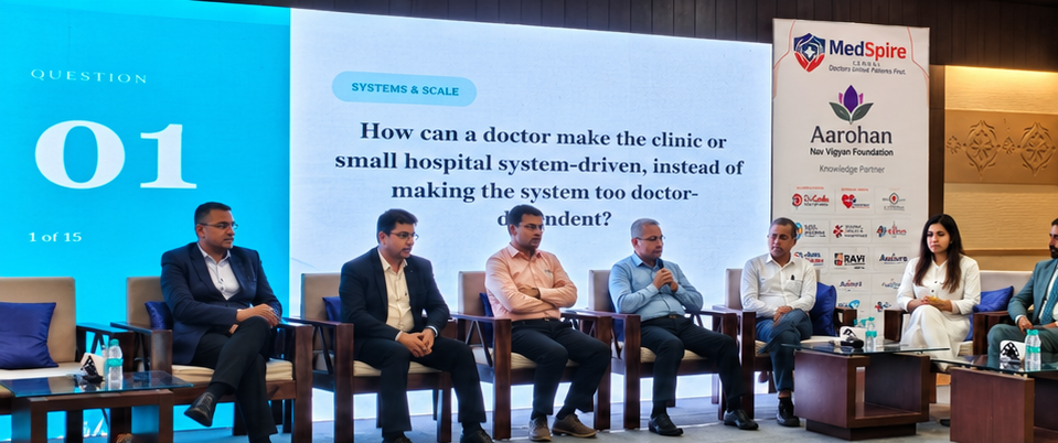 A panel of doctors and healthcare leaders discussing the first Systems & Scale question on stage