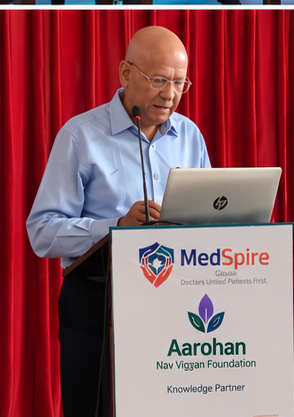 A senior doctor speaking from the MedSpire lectern